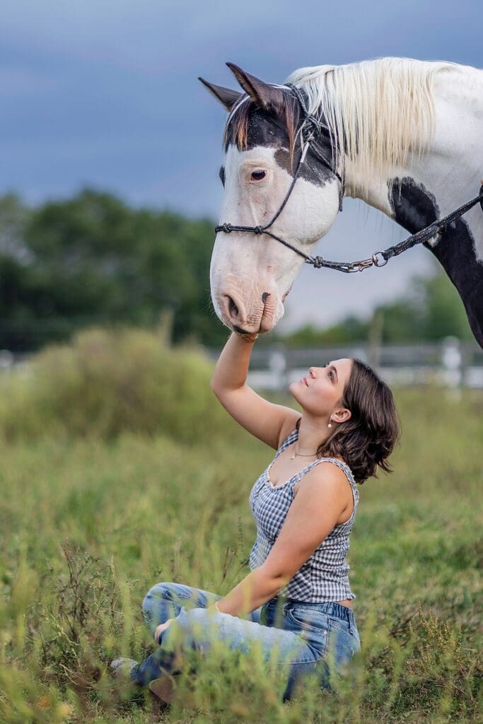 Reagan Harrison posing with hera paint horse during her Cloverdale High School model group shoot picture session in Indiana.